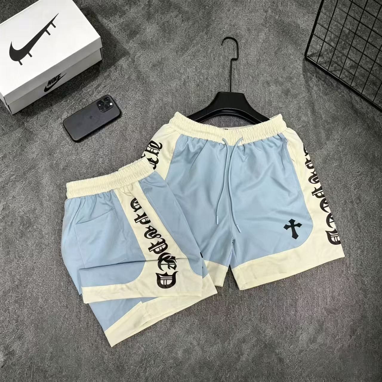 Light blue Chrome Hearts graphic shorts with cream accents.