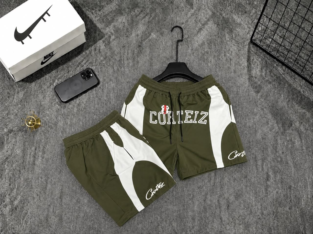 Olive Corteiz logo shorts with white panels.