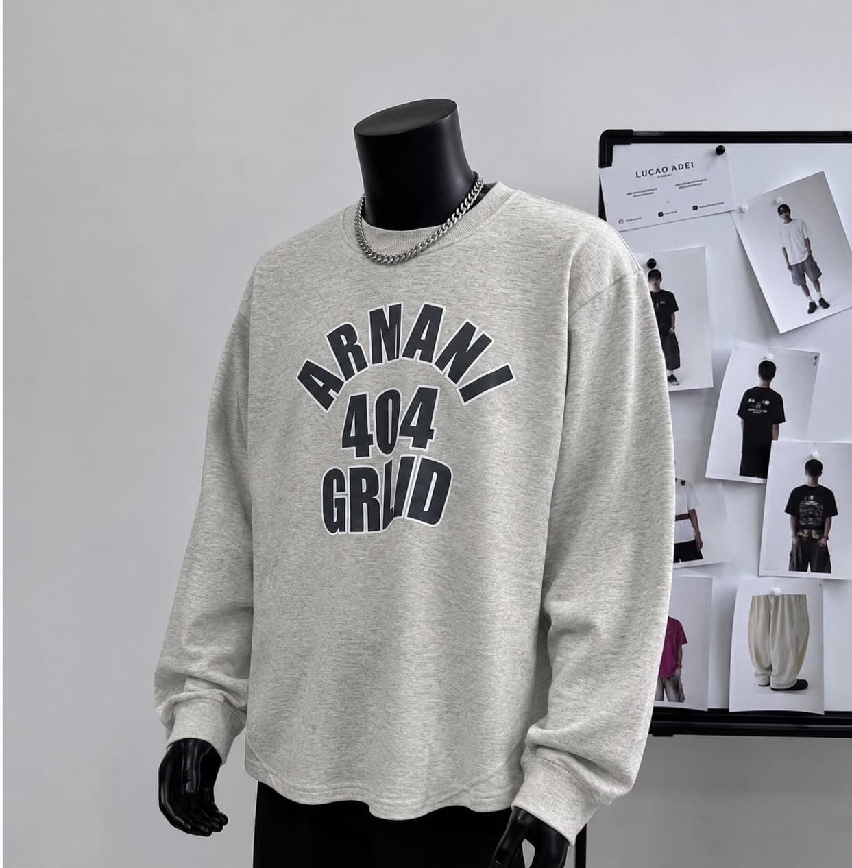 Light gray ARMANI 404 GRND sweatshirt displayed on mannequin.