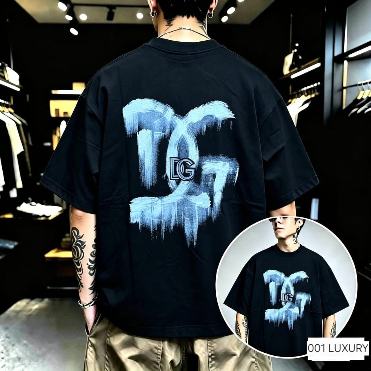 Back view of model in black oversized t-shirt with blue brush stroke logo.