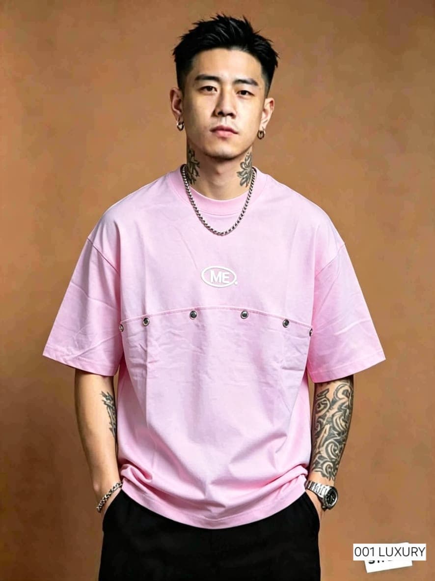 Model wearing pink oversized t-shirt with ME logo and front pocket.