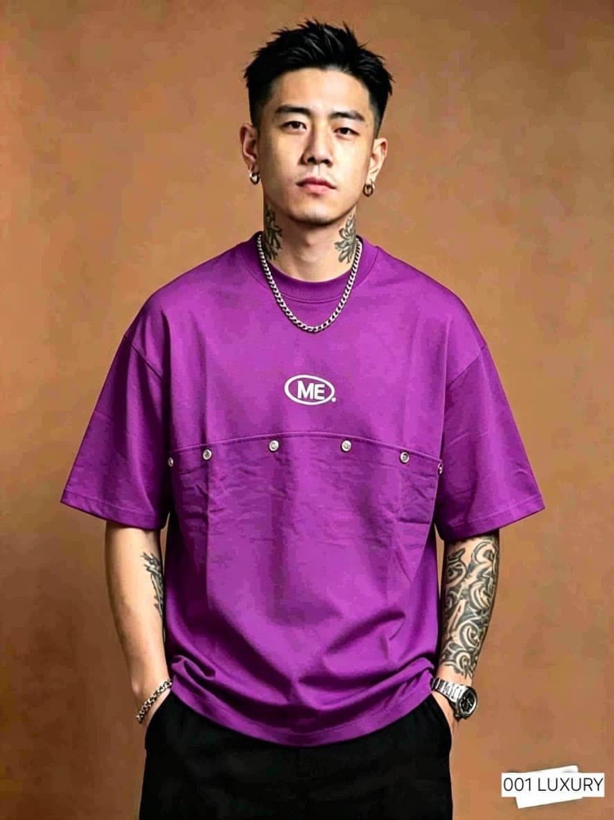 Model wearing purple oversized t-shirt with ME logo and front pocket.