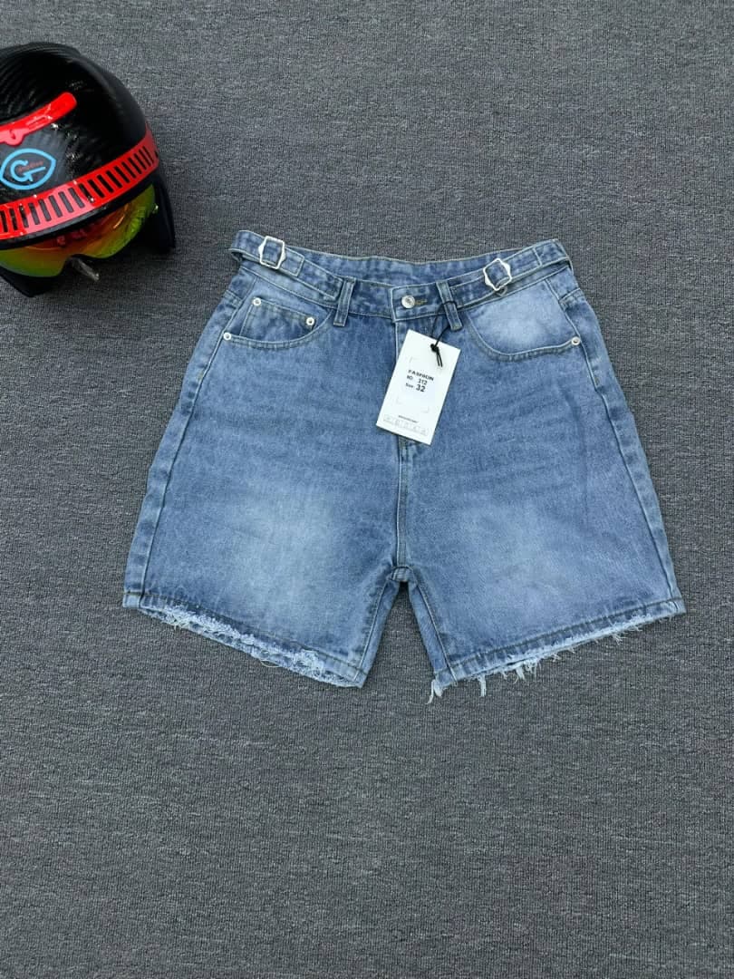 Light blue denim shorts with double buckle belt detail and attached tag, flat lay.