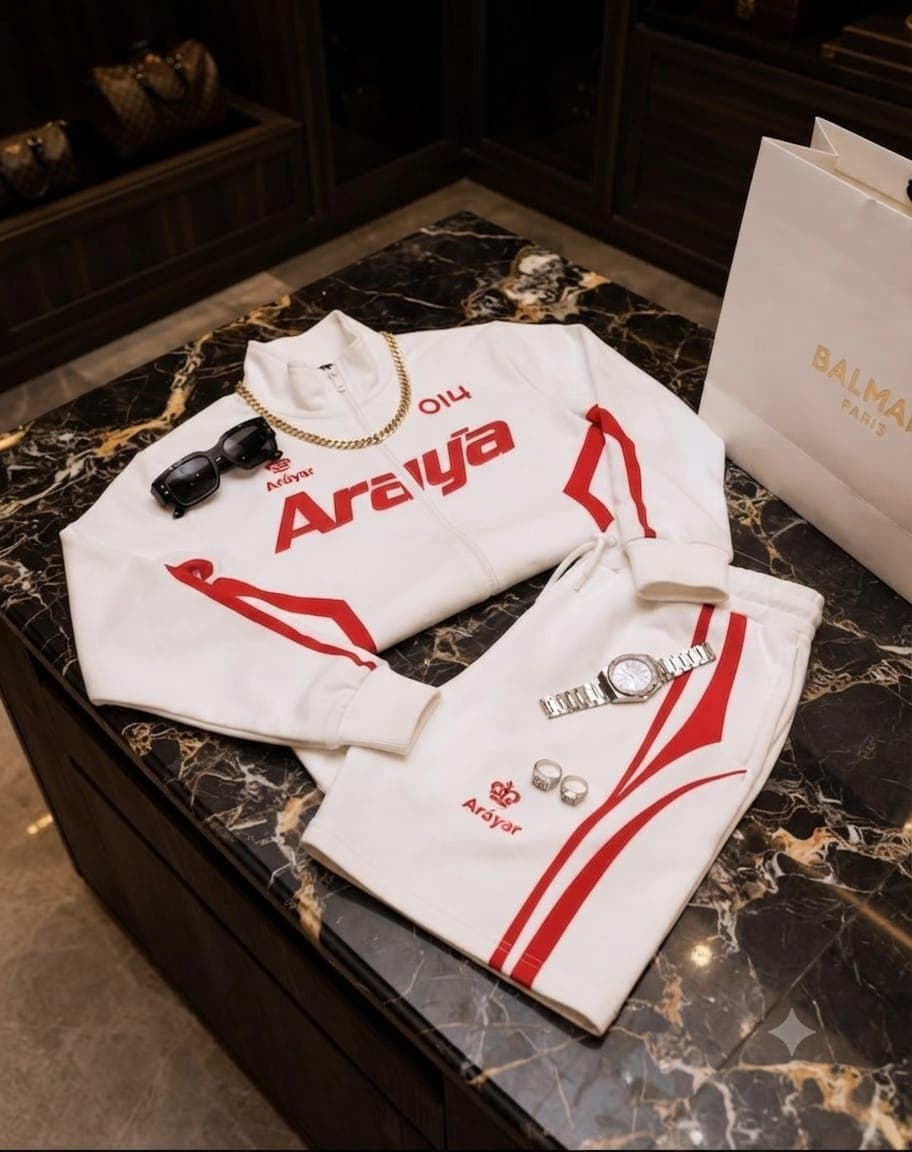White Araya set featuring red stripes and branding on jacket and shorts, with gold chain and watch accessories.