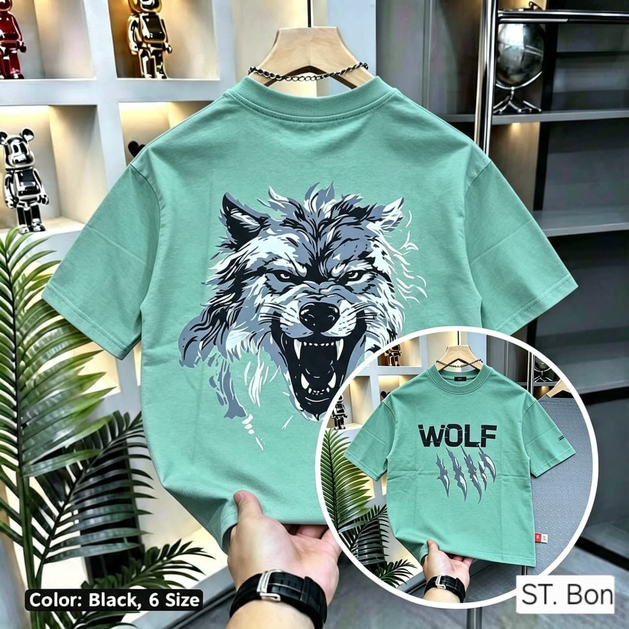 Green t-shirt with wolf head back graphic and front WOLF claw print inset.