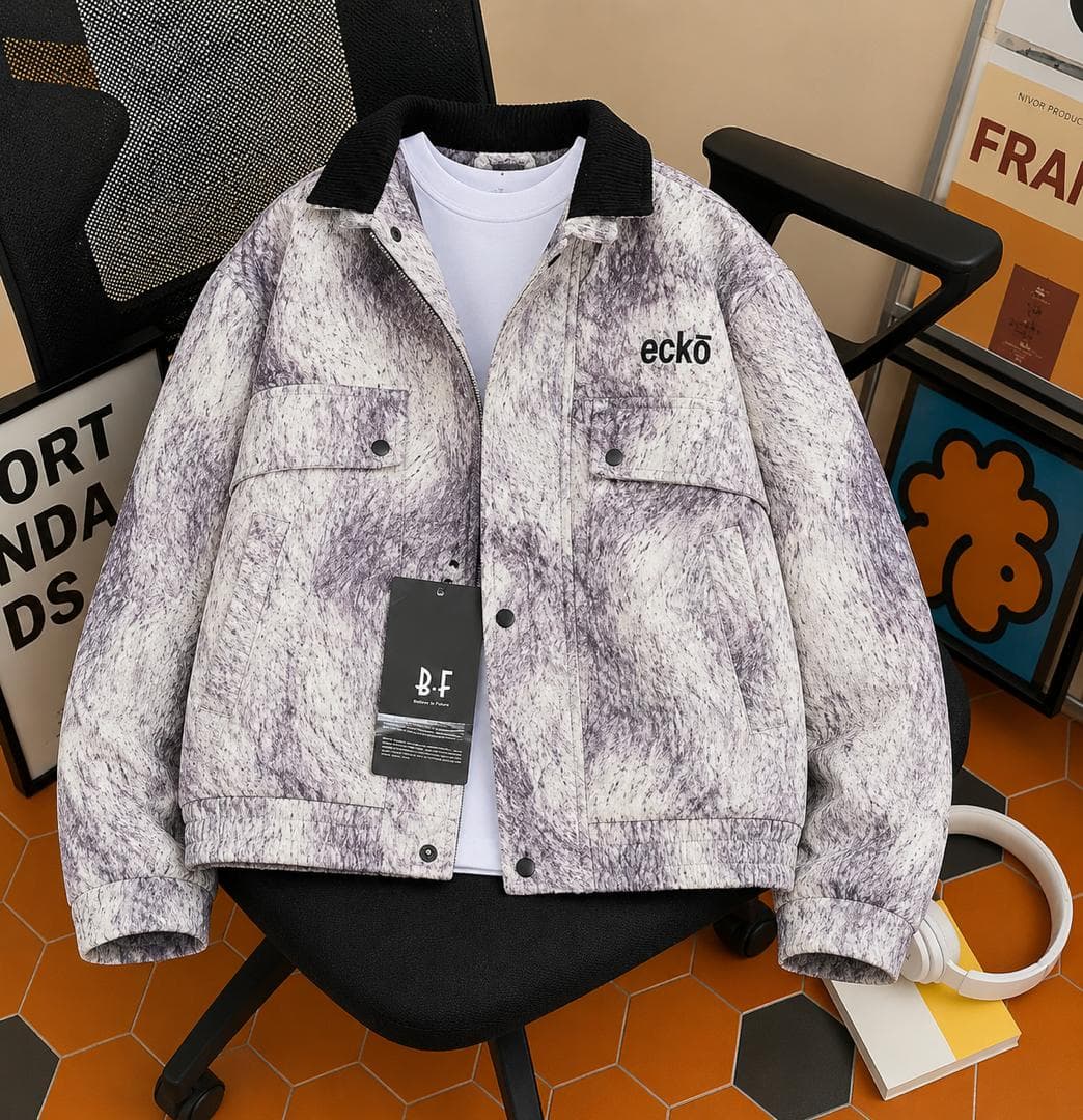 Eckö marbled gray trucker jacket worn over white tee on black chair.