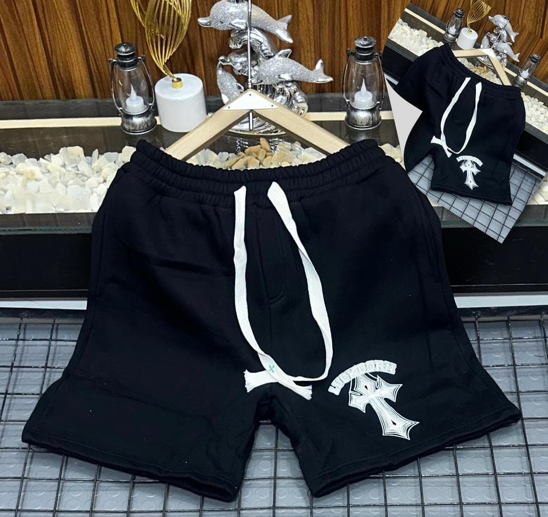 Black fleece shorts with white cross and text graphic on leg.