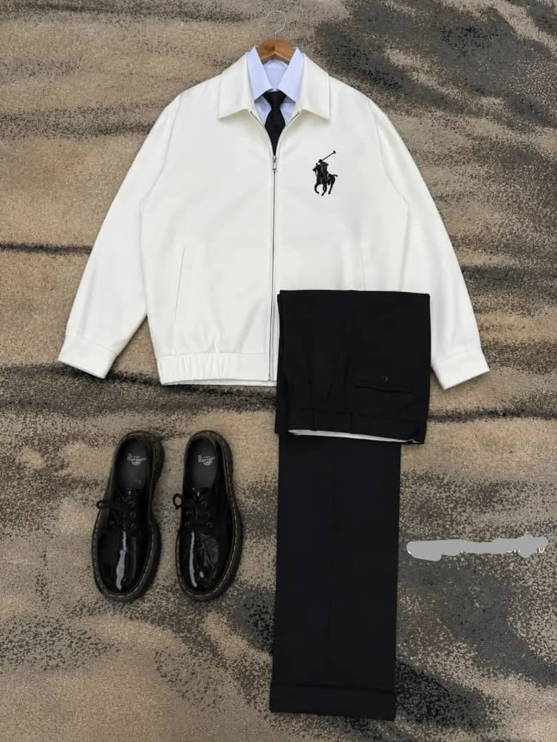 White polo zip jacket with shirt, black tie, black trousers and shoes.
