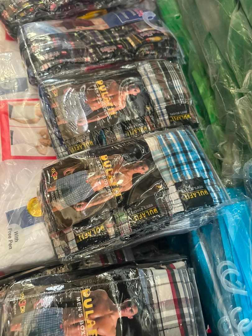 Multiple packaged Pulafit men's boxers in assorted plaid patterns.