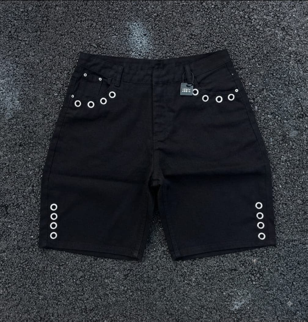Black denim shorts with white grommets on sides and back pockets.