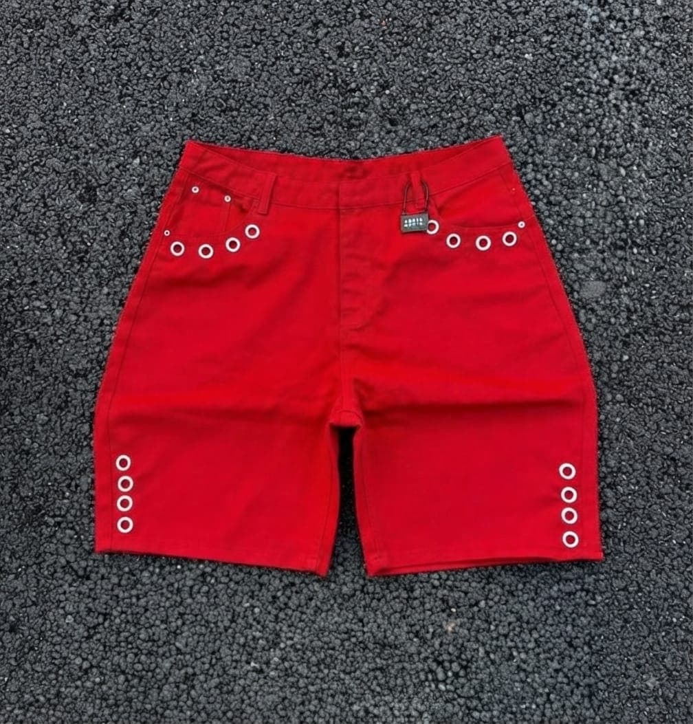 Red denim shorts with silver grommets on sides and back pockets.