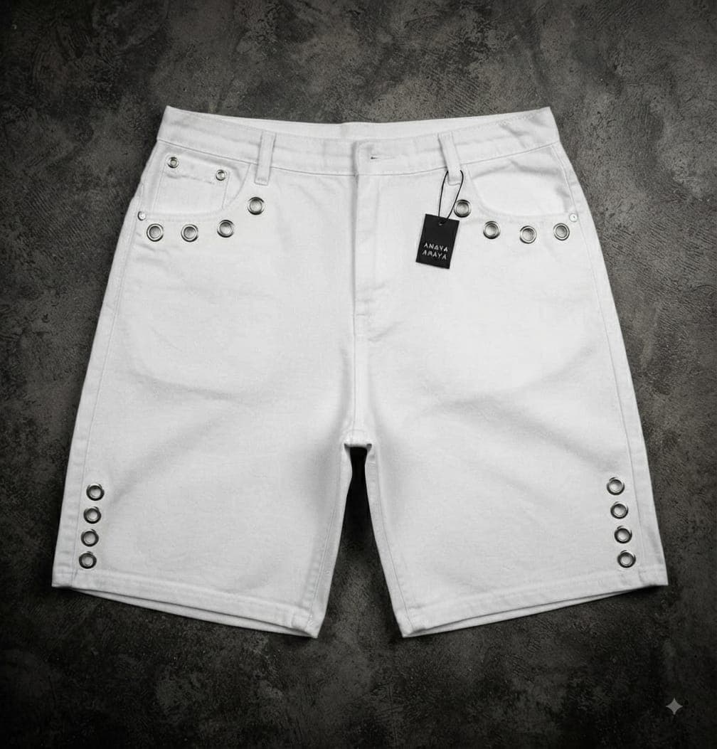 White denim shorts with silver grommets on sides and back pockets.