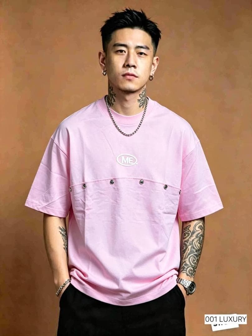 Man in pink ME. logo utility pocket oversized t-shirt, front view.
