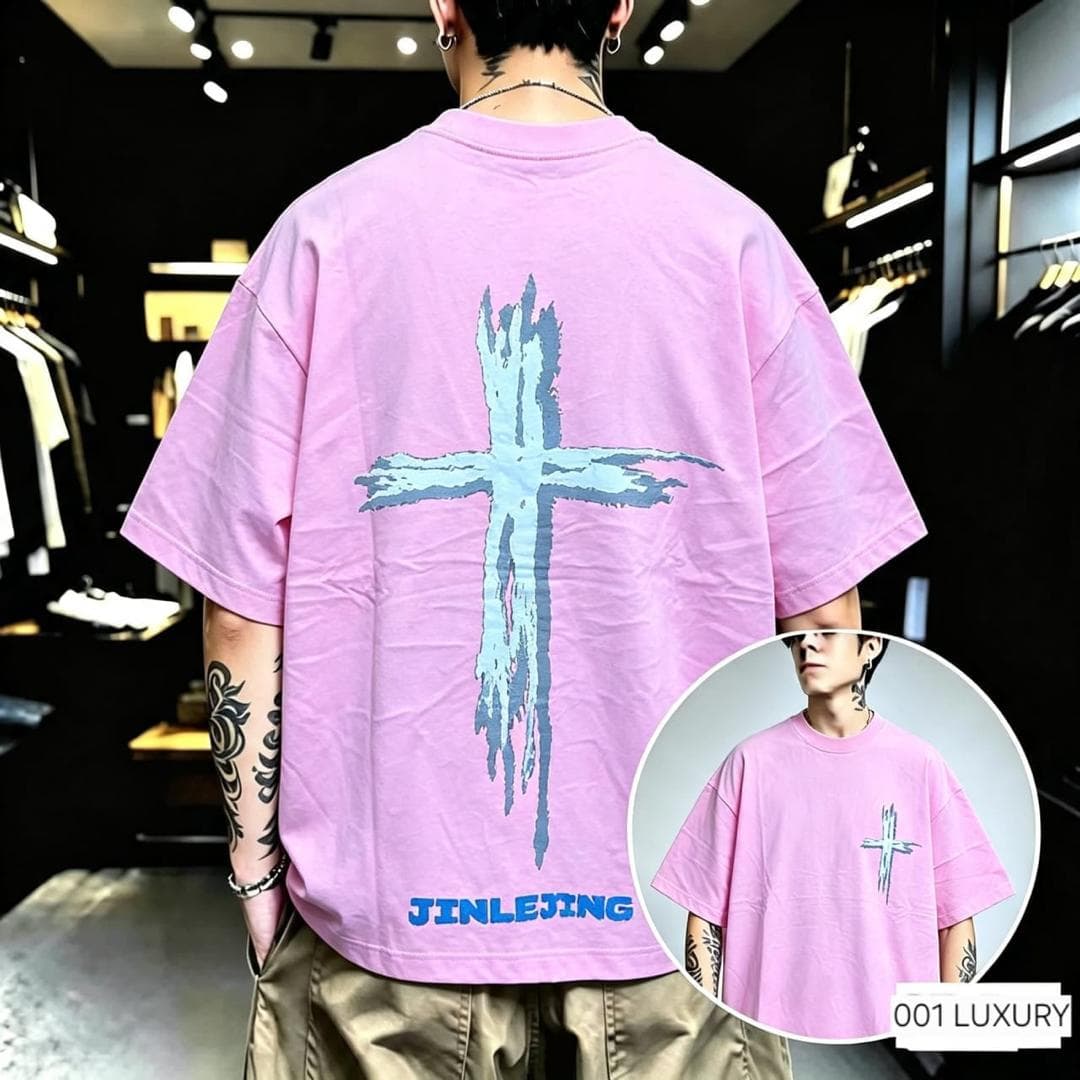 Man in pink oversized t-shirt with blue cross graphic on back and JINLEXING text.