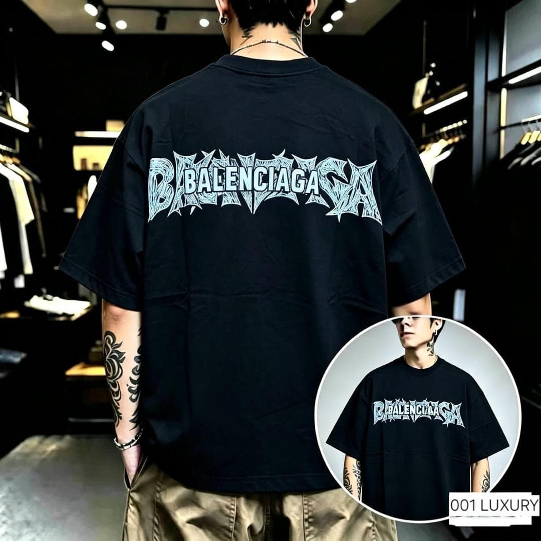 Man in black Balenciaga graphic oversized t-shirt, back view with light blue stylized logo.