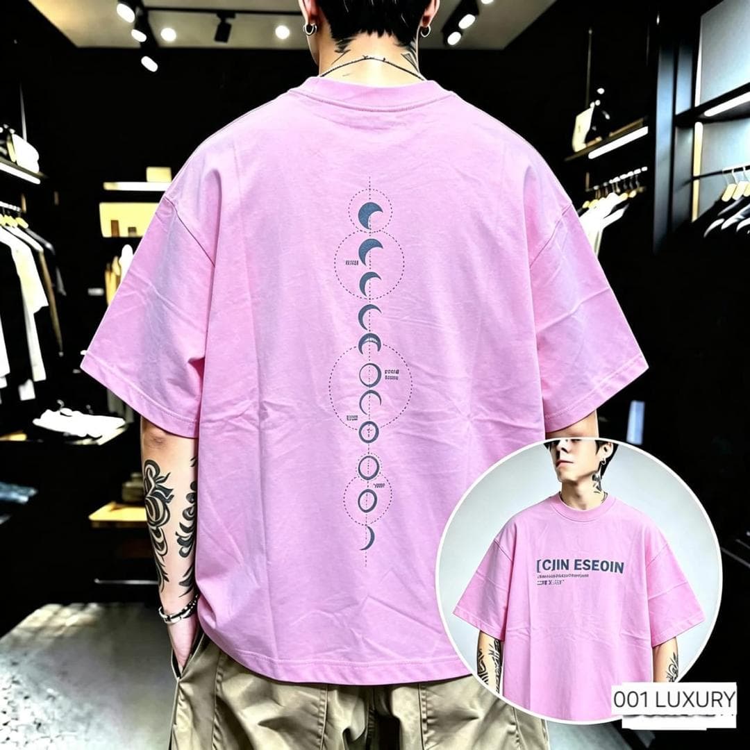 Man from back in pink oversized t-shirt with vertical moon phase graphic on back.