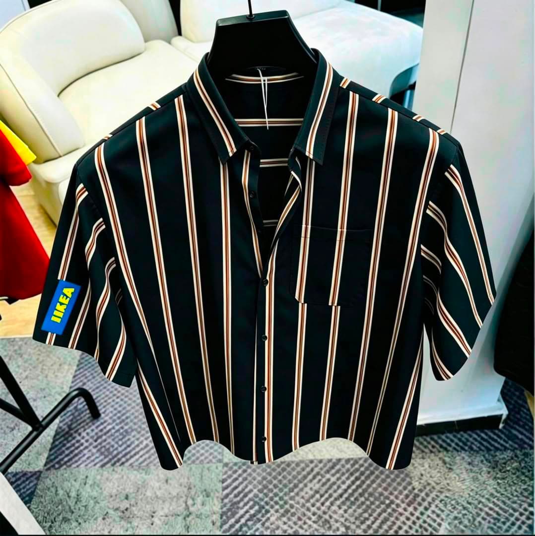 Black striped short sleeve button-down shirt with chest pocket on black hanger.