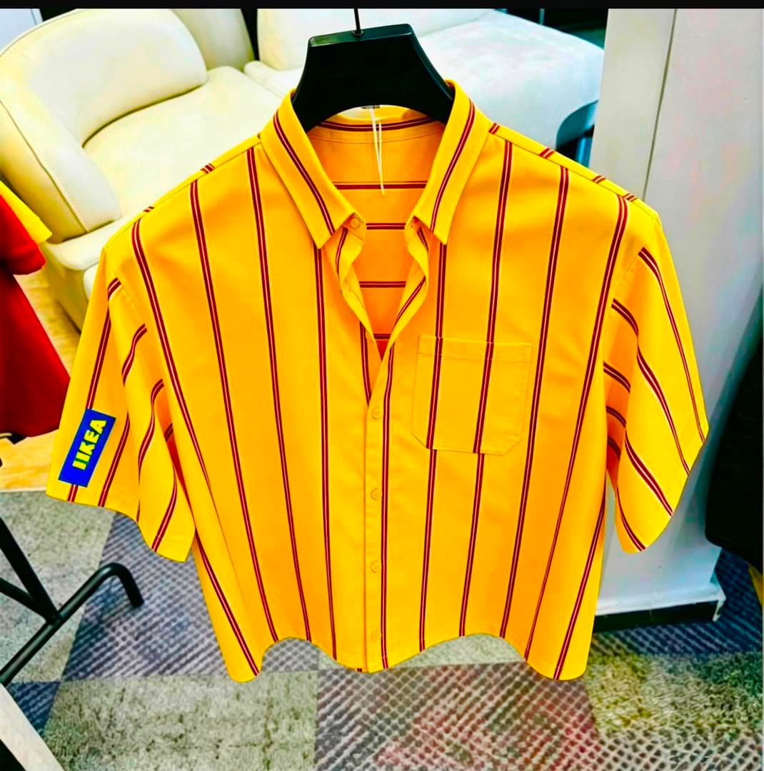 Yellow striped short sleeve button-down shirt with chest pocket on black hanger.