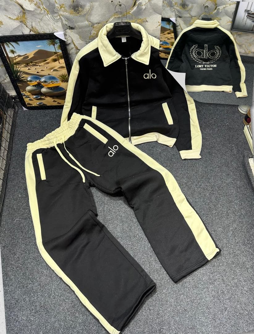 Black and cream Alo tracksuit set with zip jacket and pants.