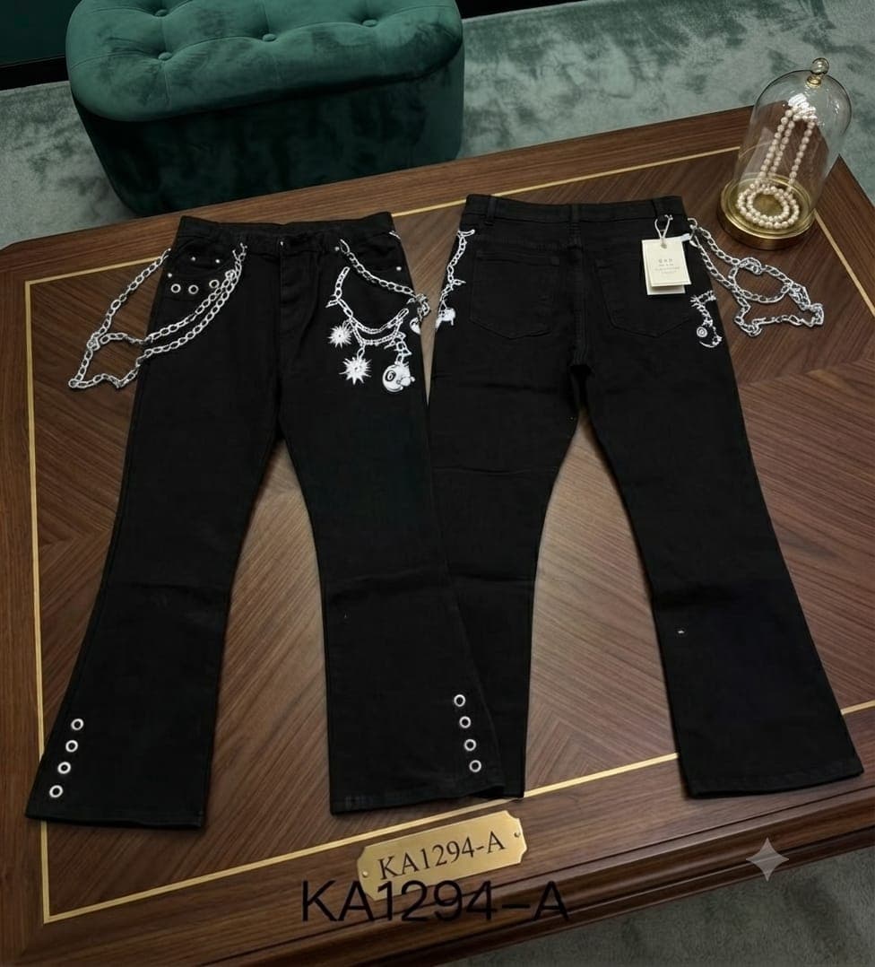 Black baggy flare jeans with white chain, skull and star prints plus metal eyelets.