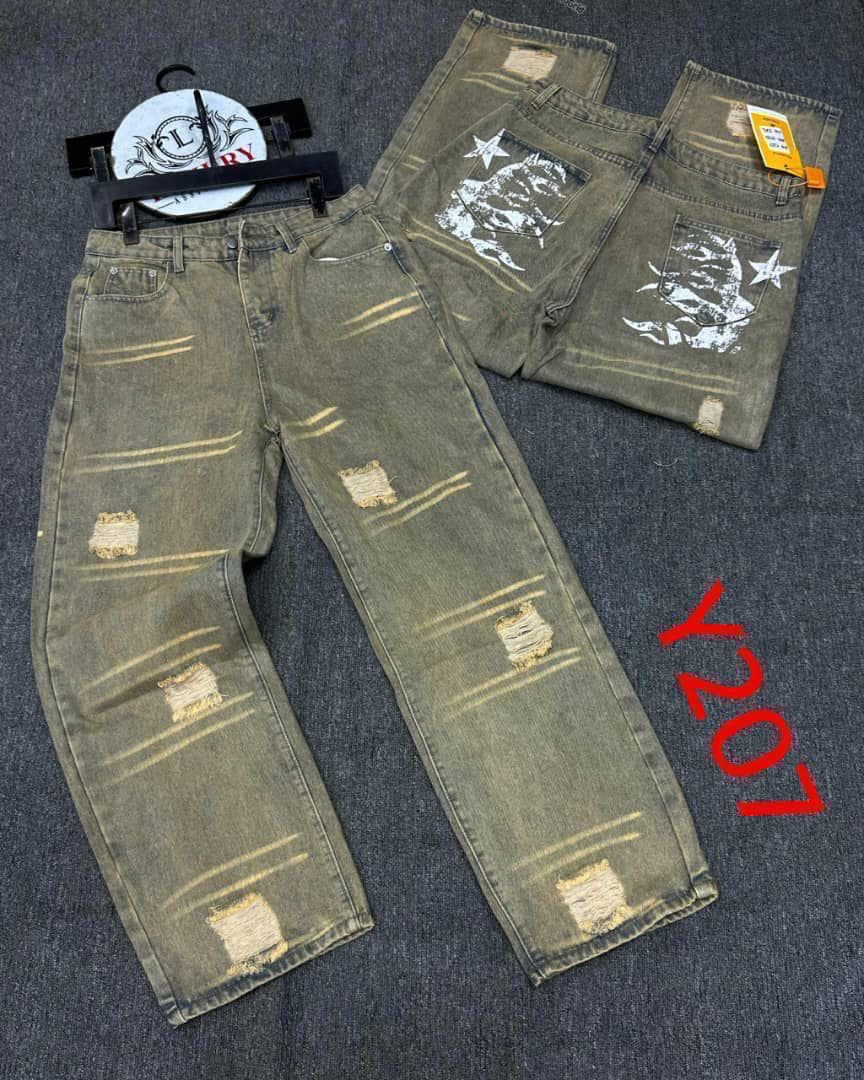 Olive green distressed baggy jeans with rips, painted lines and back graphics.