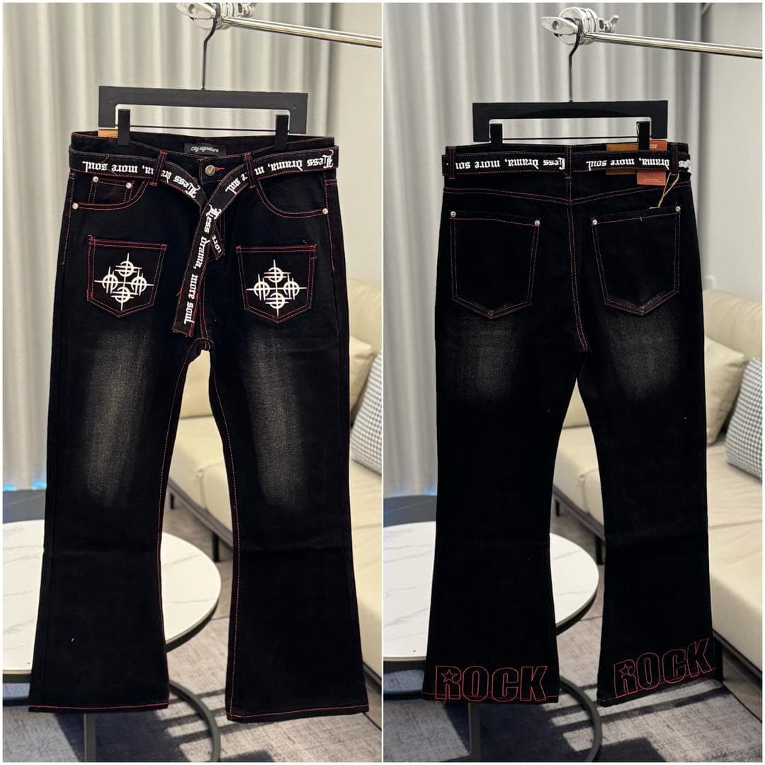 Black flared jeans showing front and back with cross embroidery on pockets and text belt.