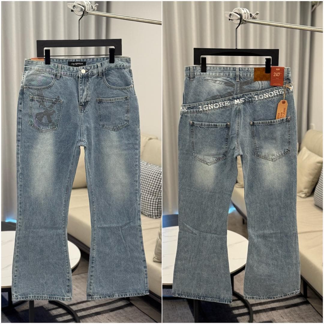 Front and back views of light blue flared jeans with back pocket graphic and IGNORE ME text.