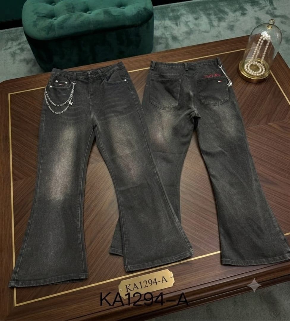Front and back views of dark gray flared jeans with chain embellishments on wooden table.