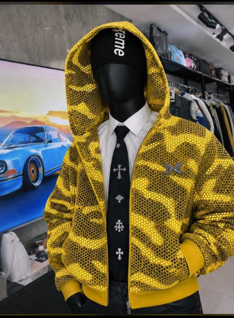 Mannequin wearing yellow camo mesh zip-up hoodie with shirt and tie.