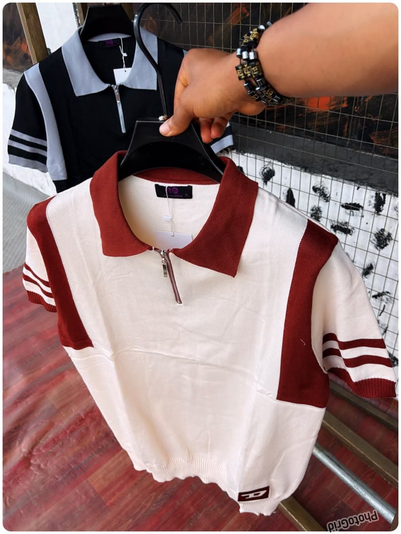 White and burgundy colorblock knit polo in front with black and gray version in background.