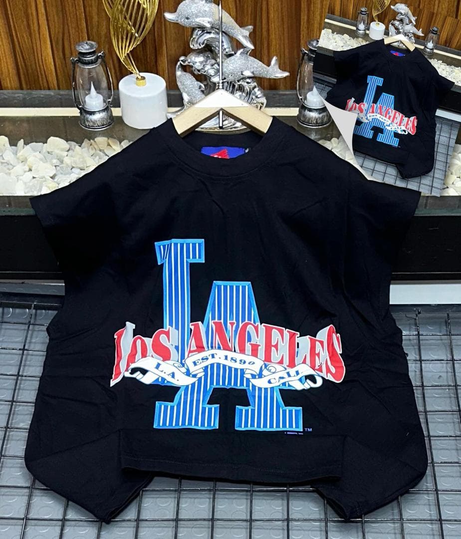 Black oversized sleeveless sweatshirt with colorful LA graphic print laid flat.