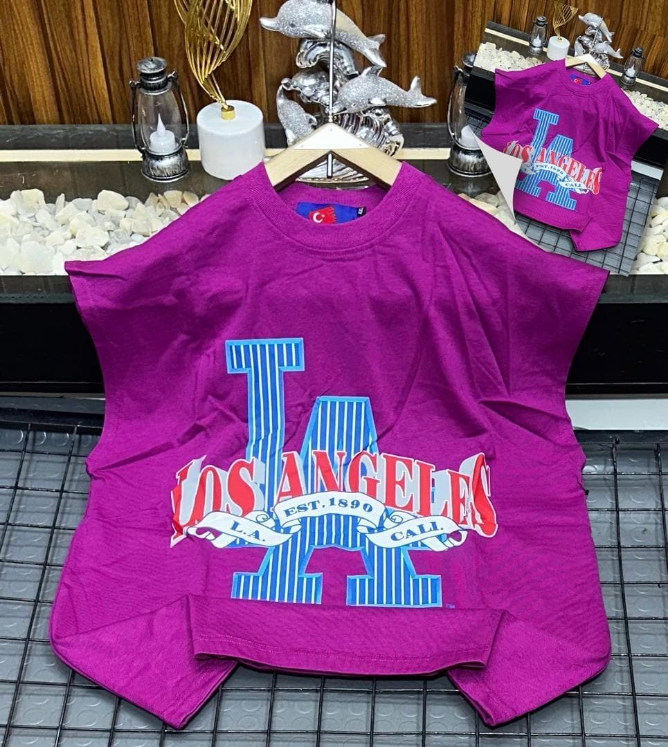 Purple oversized sleeveless sweatshirt with colorful LA graphic print laid flat.