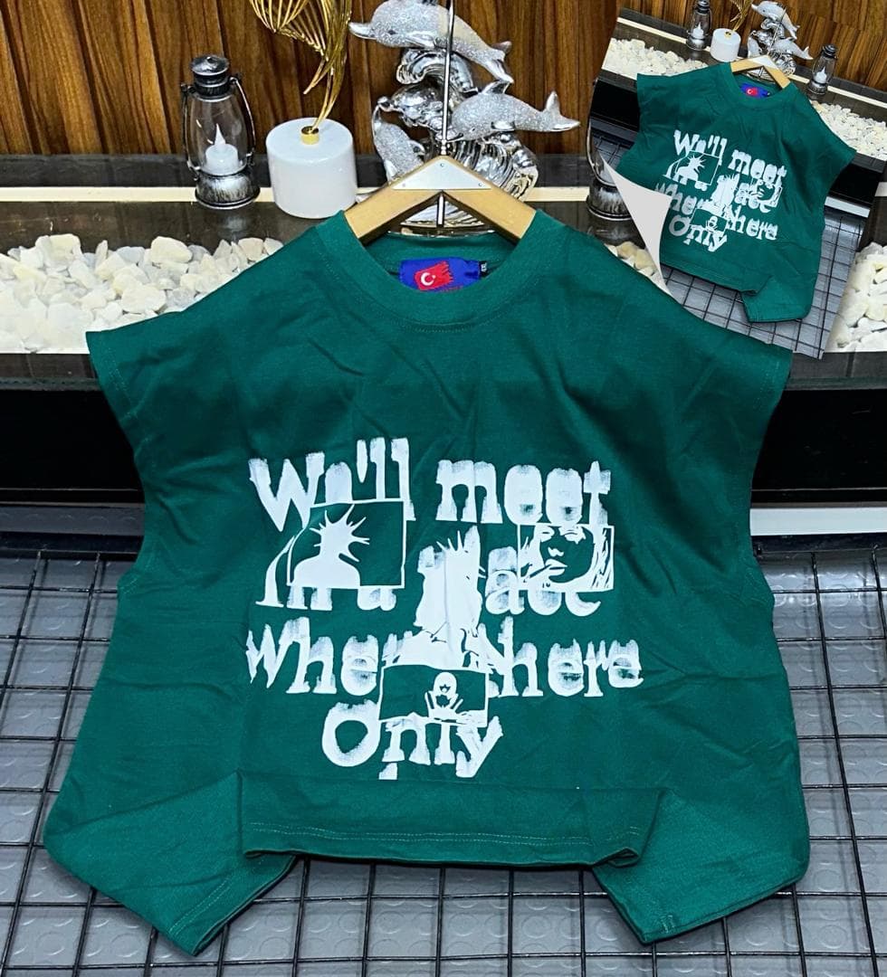 Green oversized sleeveless sweatshirt with white graphic print laid flat.