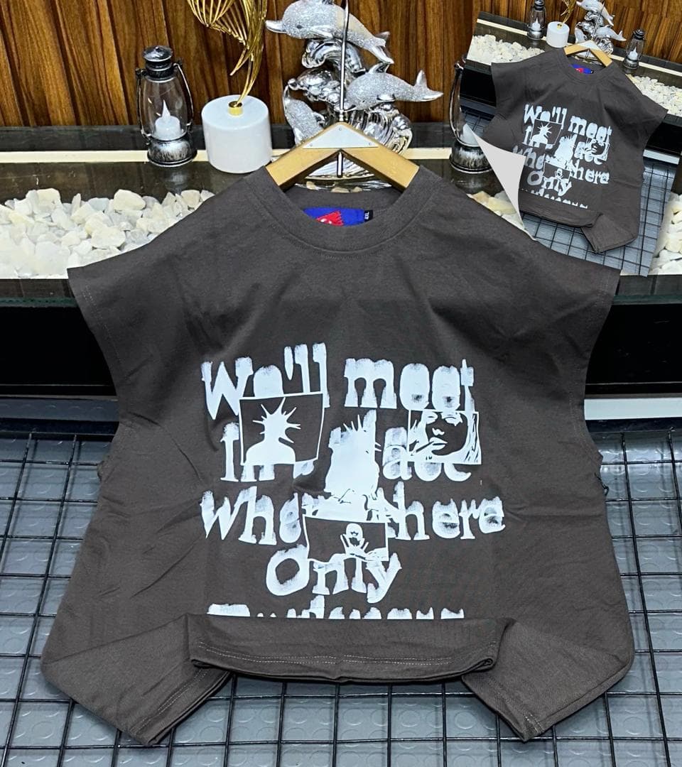 Brown oversized sleeveless sweatshirt with white graphic print laid flat.