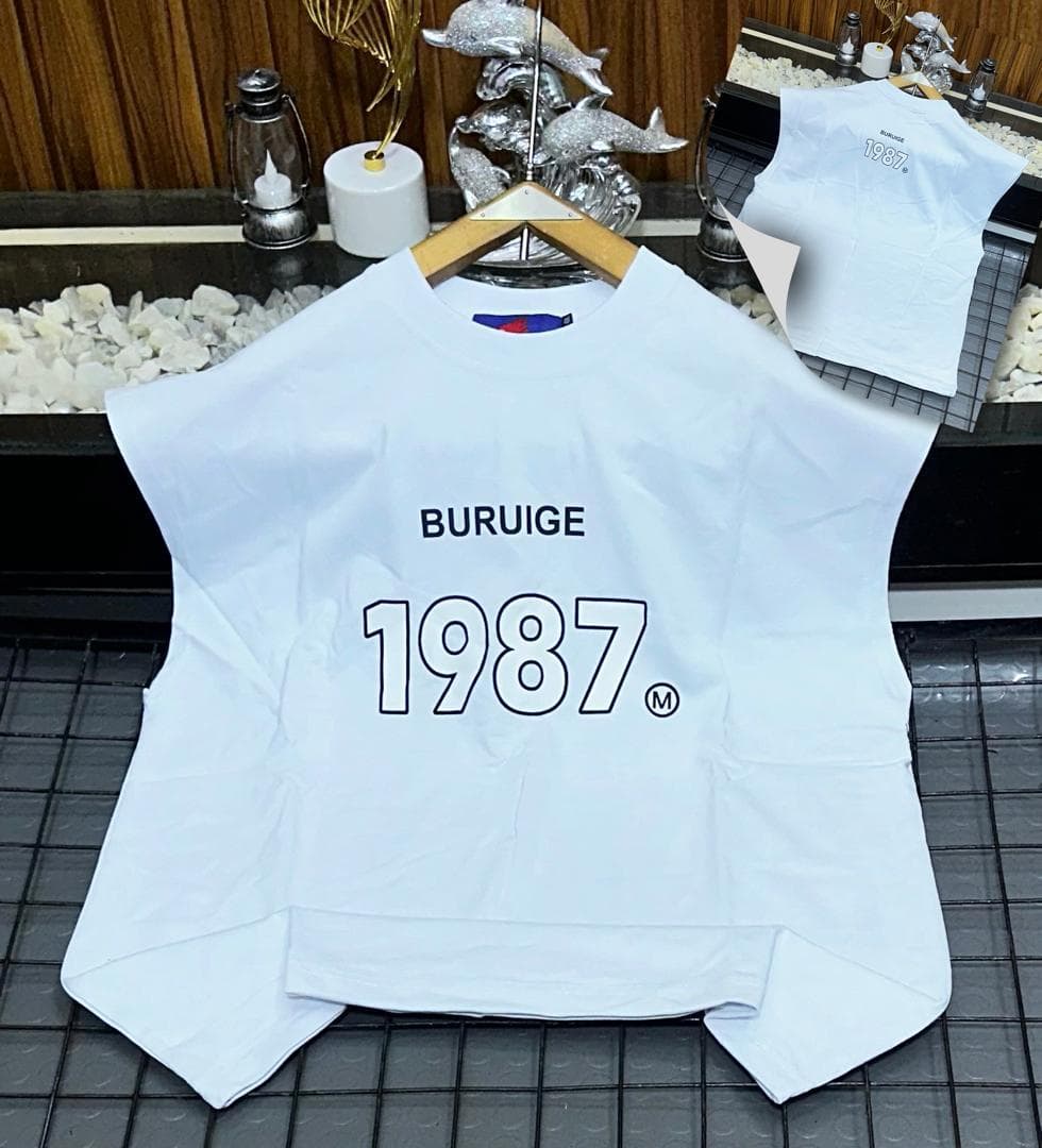 White Buruige 1987 sleeveless sweatshirt on hanger with back inset view.