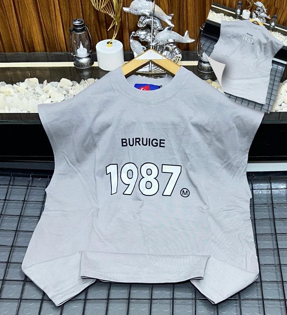 Gray Buruige 1987 sleeveless sweatshirt on hanger with back inset view.