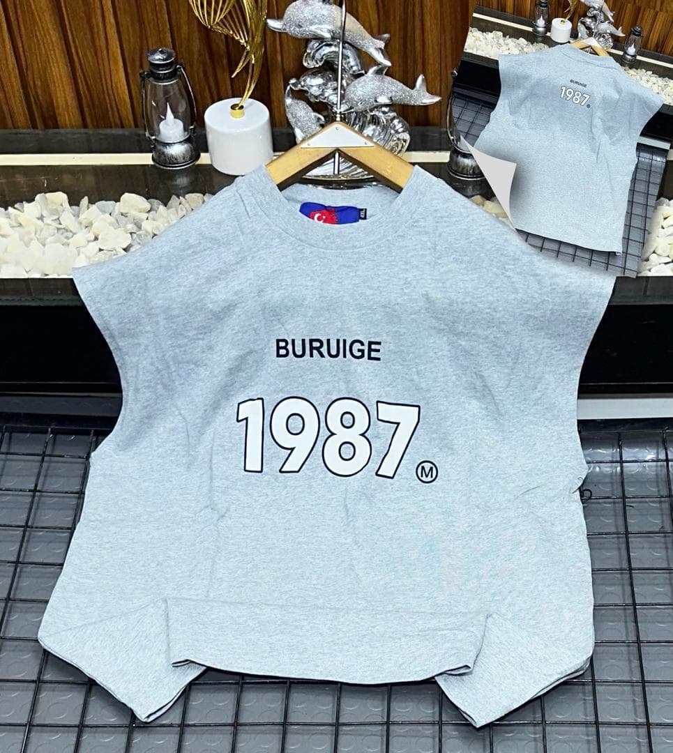 Gray Buruige 1987 sleeveless sweatshirt on hanger with back inset view.