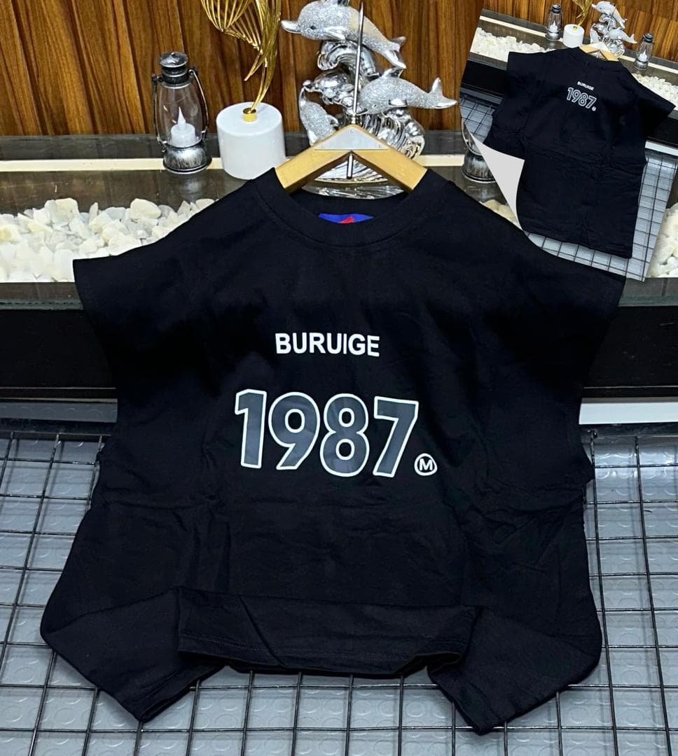 Black Buruige 1987 sleeveless sweatshirt on hanger with back inset view.