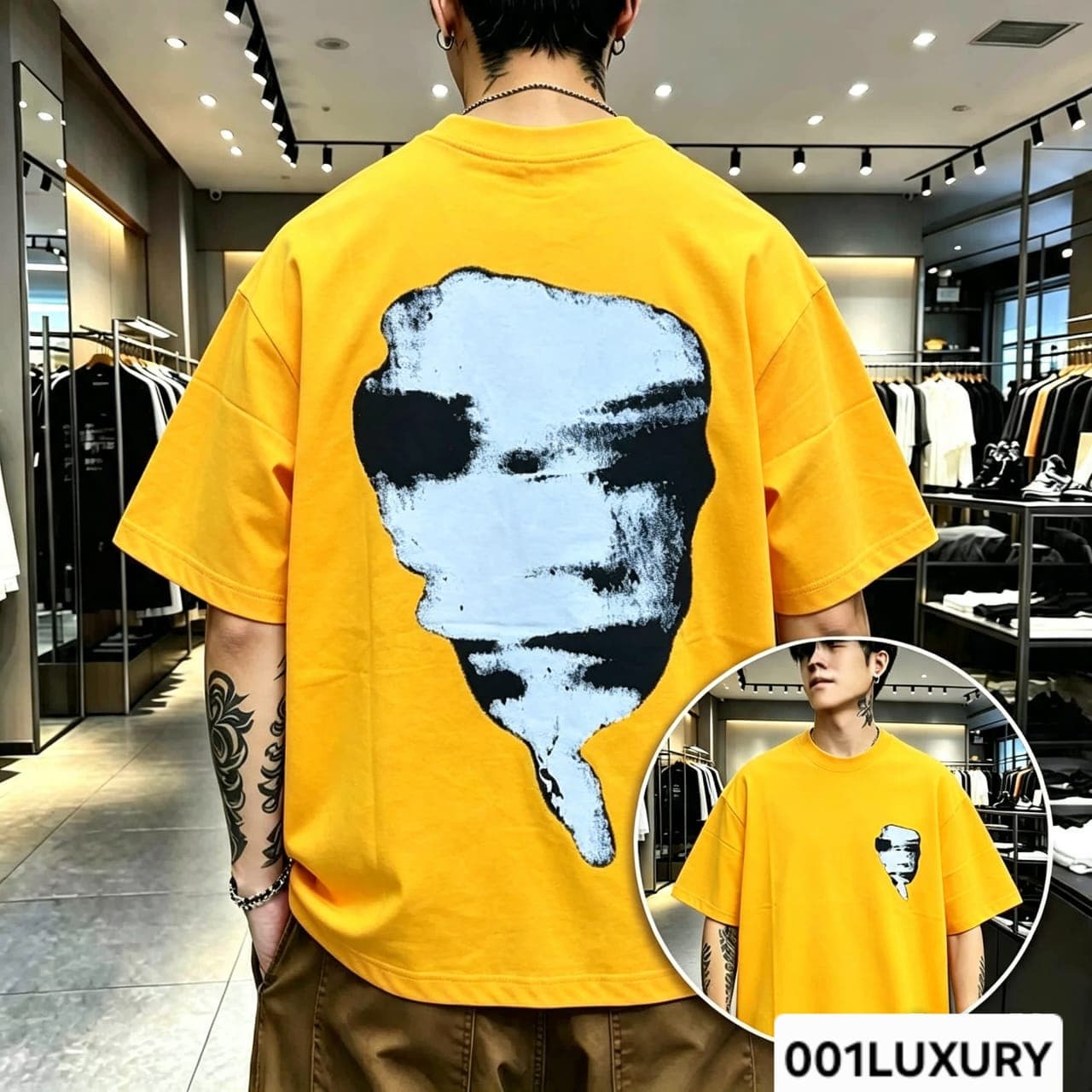 Man viewed from back wearing yellow oversized t-shirt with large abstract face graphic print.