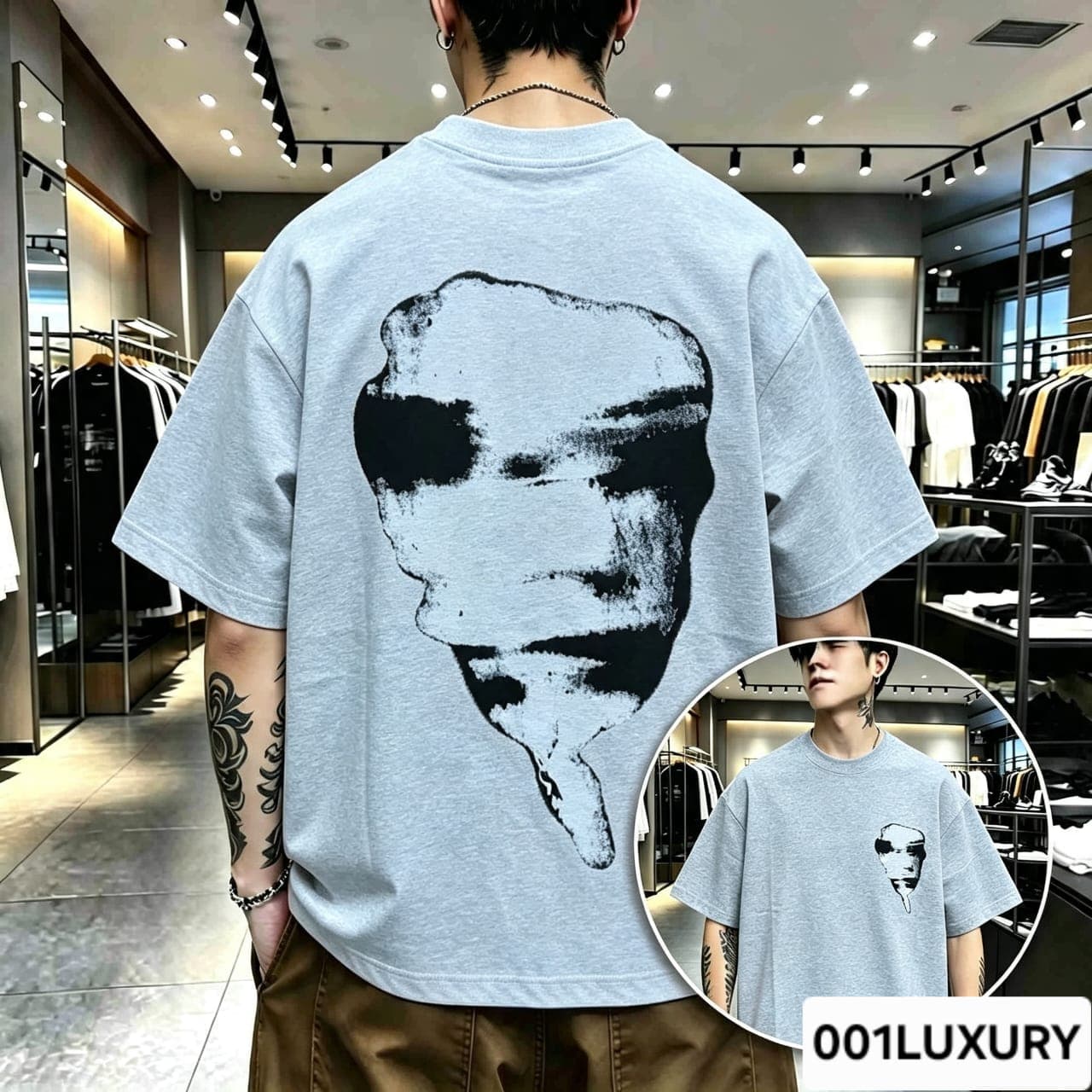 Man viewed from back wearing gray oversized t-shirt with large abstract face graphic print.