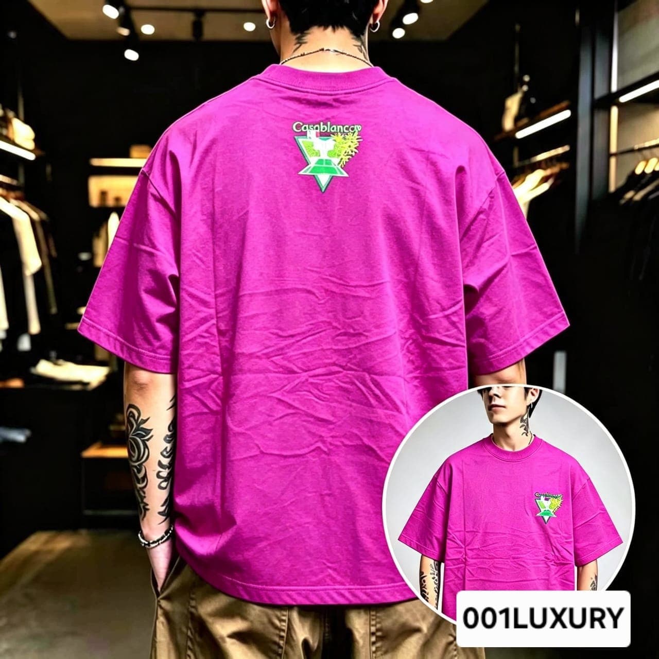 Man viewed from back wearing magenta oversized t-shirt with large Casablanca triangular graphic print.
