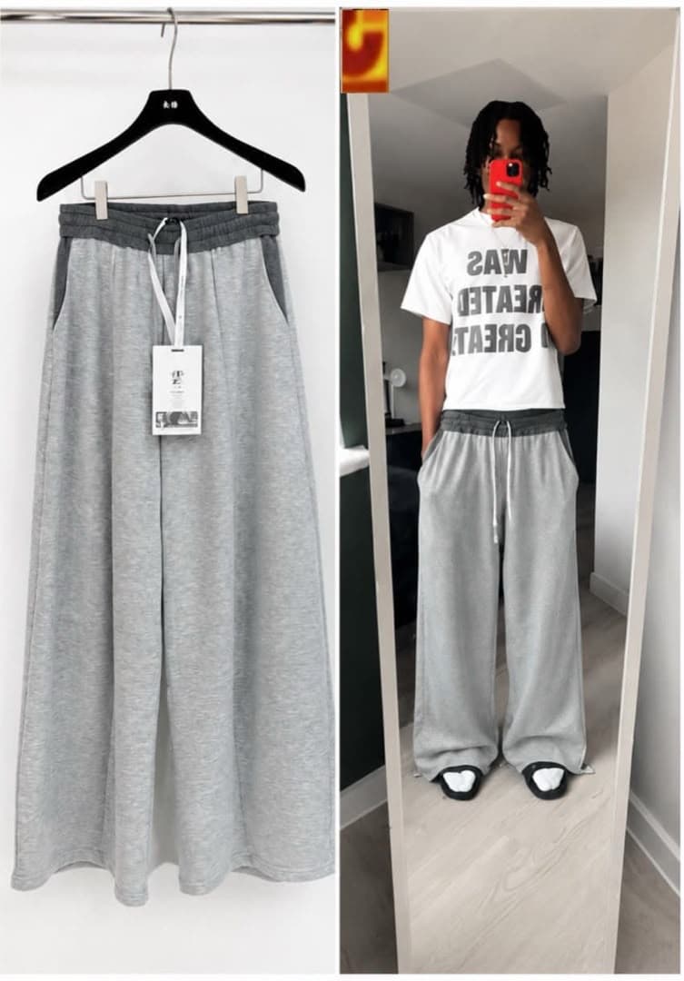 Gray wide-leg joggers on hanger and worn by model with white graphic t-shirt.