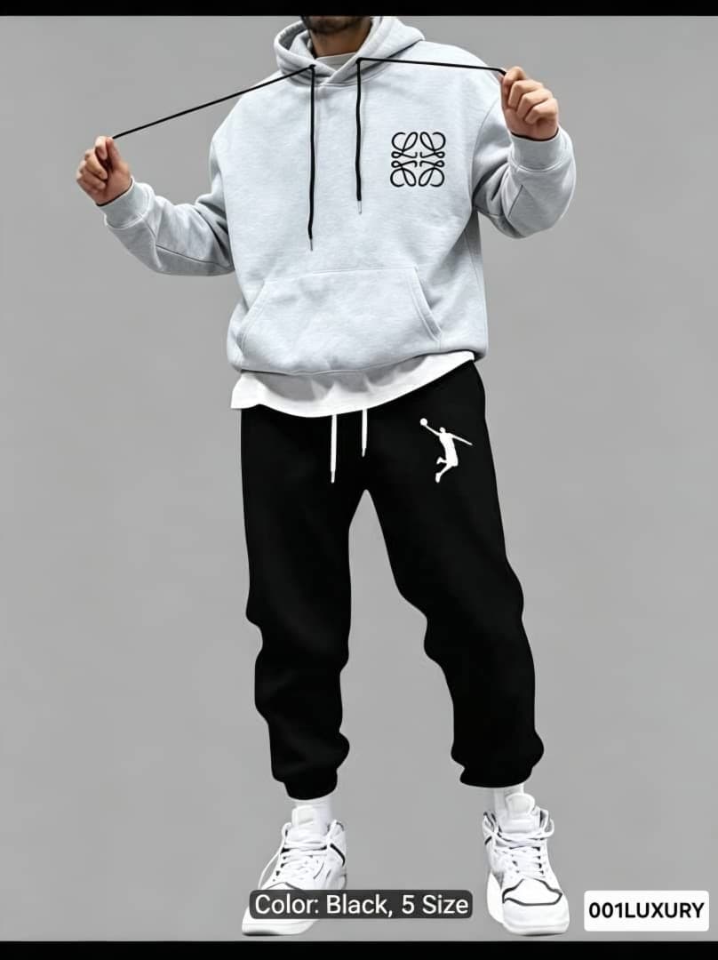 Model wearing gray Loewe hoodie with chest logo paired with graphic pants.