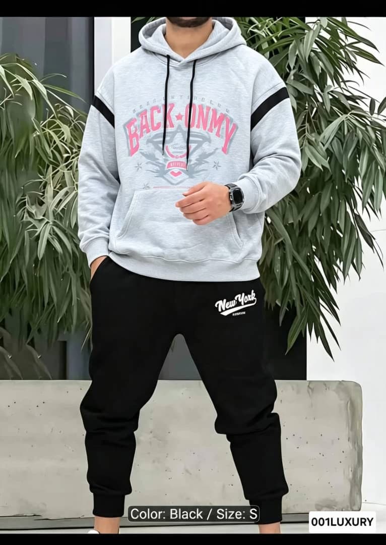 Man in gray Back Onmy graphic hoodie with hand in pocket.