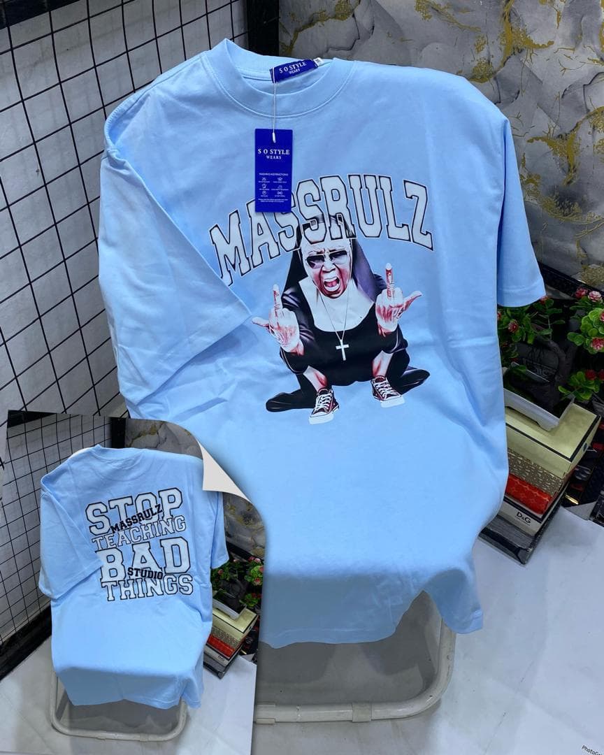 Light blue t-shirt with Massrulz nun middle finger graphic, back inset with stop teaching bad things text.