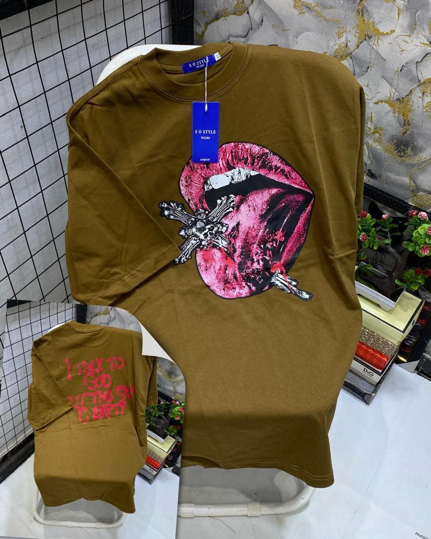 Olive t-shirt with pink lips, cross and gun graphic on front, inset back view with red text print.
