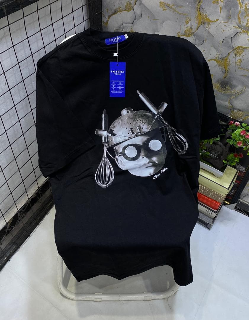 Black t-shirt with kitchen utensils and face portrait graphic print.