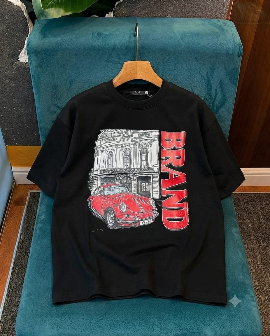 Black oversized crop tee with red vintage car, building illustration and vertical BRAND text.
