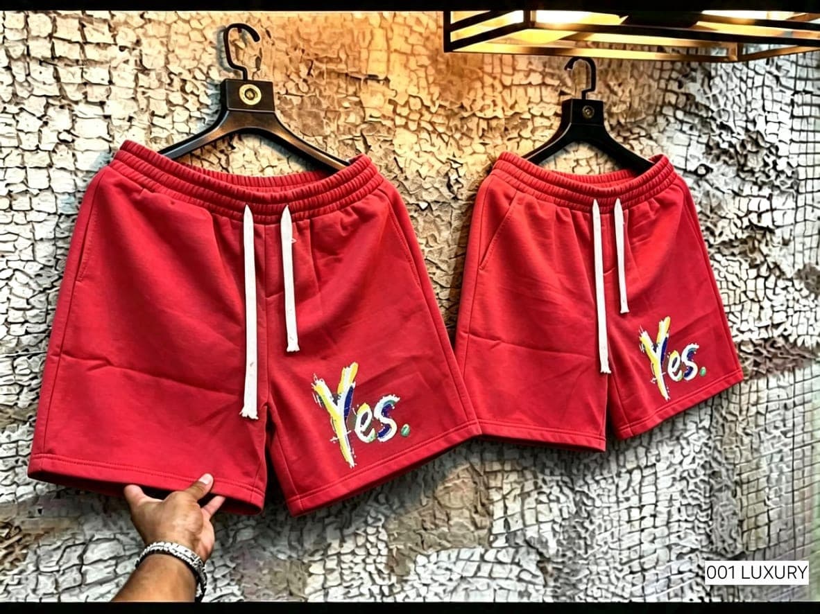 Red fleece shorts with Yes graphic on the leg, shown hanging.