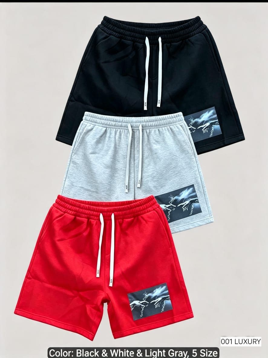 Black, light gray and red shorts with graphic print displayed together.